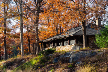 Fototapeta na wymiar Stone building in woods in Harriman State Park, NY during Fall season.