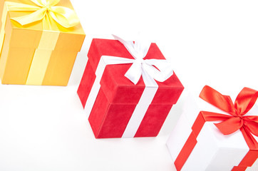 Christmas red and white and golden gift boxes stay in line with copy space. Isolated on white