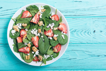Obraz na płótnie Canvas Strawberry salad with spinach , cheese and walnut . Healthy food