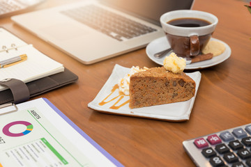 Business and finance concept of working, Working desk in coffee shop with dessert.