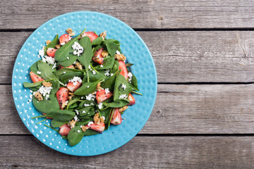 Strawberry salad with spinach , cheese and walnut . Healthy food