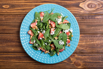 Strawberry salad with spinach , cheese and walnut . Healthy food