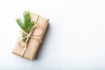 Christmas composition. Christmas gift, pine cones, fir branches on stone white background. Flat lay, top view, copy space
