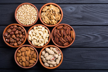 Mix of nuts : Pistachios, almonds , walnuts , pine nut , hazelnuts and cashew . Snack in bowl backgrond