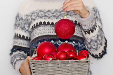Toys on the Christmas tree in the hands of the girl