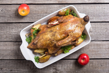 Homemade baked duck with potatoes and apple . Christmas food