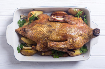 Homemade baked duck with potatoes and apple . Christmas food
