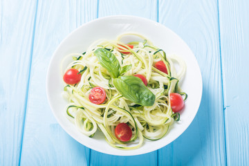 Zucchini pasta noodles with tomatoes . Healthy vegetarian food