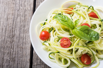 Zucchini pasta noodles with tomatoes . Healthy vegetarian food