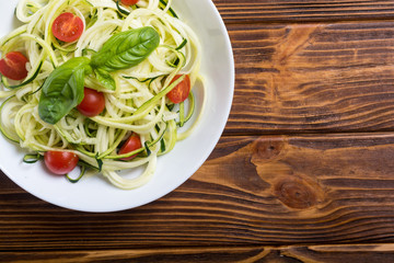 Zucchini pasta noodles with tomatoes . Healthy vegetarian food