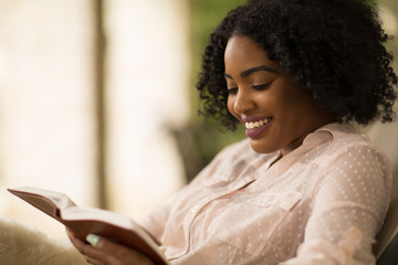 African American woman studing and reading the Bible. - Powered by Adobe