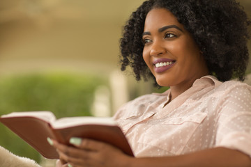 African American woman studing and reading the Bible.