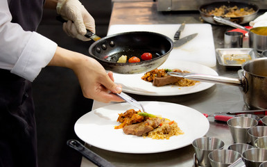 Chef preparing food, meal, in the kitchen, chef cooking, Chef decorating dish, closeup, .Chef preparing food, meal, in the kitchen, chef cooking, Chef decorating dish, closeup, .
