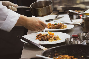 Chef preparing food, meal, in the kitchen, chef cooking, Chef decorating dish, closeup, .Chef preparing food, meal, in the kitchen, chef cooking, Chef decorating dish, closeup, .