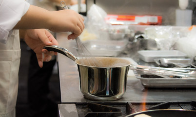 Chef preparing food, meal, in the kitchen, chef cooking, Chef decorating dish, closeup, .Chef preparing food, meal, in the kitchen, chef cooking, Chef decorating dish, closeup, .