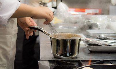 Chef preparing food, meal, in the kitchen, chef cooking, Chef decorating dish, closeup, .Chef preparing food, meal, in the kitchen, chef cooking, Chef decorating dish, closeup, .