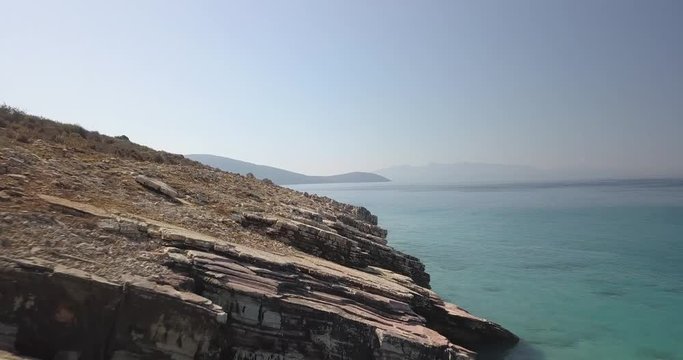Drone video flying over rocks at lukova beach in South Albania