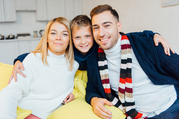 Fototapeta premium loving parents and smiling son looking at camera