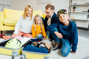 happy family having great time and packing for winter holidays, travel concept