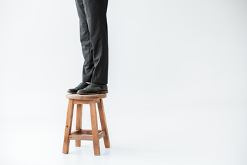partial low section view of girl in formal wear standing on steel isolated on grey