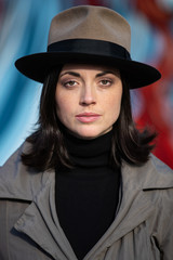 Fototapeta premium Pretty and stylish woman wearing a hat and coat outside