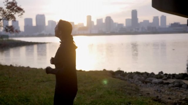 Young healthy female running outside city sunrise, HD, slow motion.