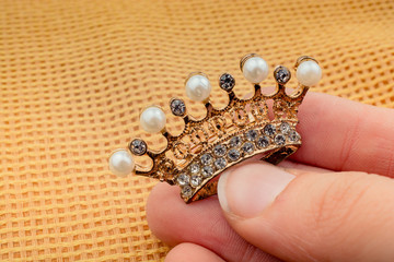 Model crown with pearls in hand