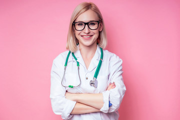 Female young and beautiful blond woman veterinary doctor using stethoscope in a white medical coat...