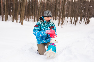 Fototapeta na wymiar Jack Russell Terrier dog with owner woman playing in the winter outdoors.