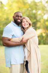 Fototapeta premium Loving mixed race couple hugging and laughing.