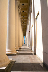 A long corridor between columns, perspective view. Collonade.