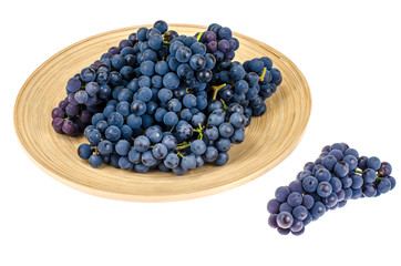 Wooden dish with black grapes