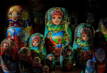 Colorful traditional Russian matryoshka nesting dolls in a souvenir shop in Saint Petersburg Russia with a dramatic high contrast lighting