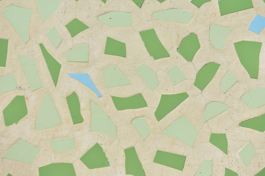 Tiles background. Brown, green and blue tiles texture. Rugged surface with sun light.