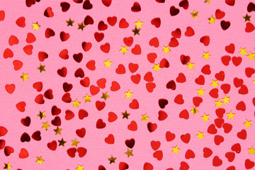 Pink background with red confetti hearts and golden stars for Valentine Day