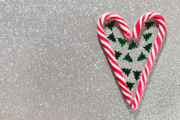 A heart formed with Christmas sticks and confetti as New Year background with copy space
