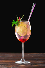 glass of delicious alcoholic cocktail on dark background