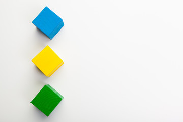 Colorful wooden building blocks isolated on white background