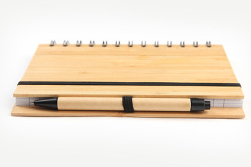 Notebook with pen on white isolated background