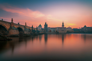 Beautiful sunrise panoramic view over Charles Bridge on Vltava River and old historical town in Prague, Czech Republic, Europe