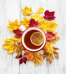 autumn flat lay with cup of tea and leaves