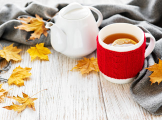Cup of tea and autumn leaves