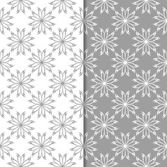 White and gray floral backgrounds. Set of seamless patterns