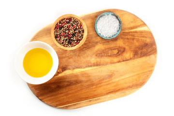 A cutting board, shot from above on a white background with salt, pepper, and olive oil. A cooking frame with a place for text
