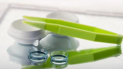  contact lenses, tweezers and container