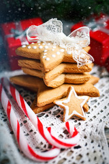 Merry Christmas and happy New year. Cookies gifts and fir tree branches on a wooden table. Selective focus. Christmas background.