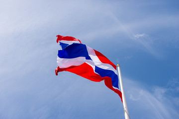 Thai flag waving with cloud and blue sky in background with copy space