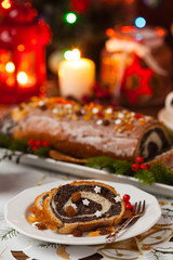 Poppy seed roulade in Christmas decoration. Served with coffee or tea.