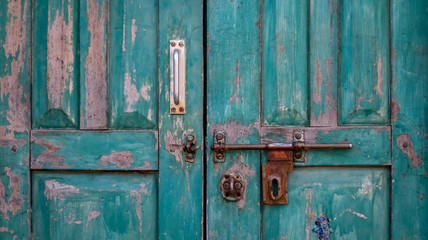 Closed old wooden door with open lock. Vintage