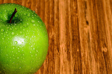 Single Green Apple with water Drops on the surface.  There is Room for Copy.